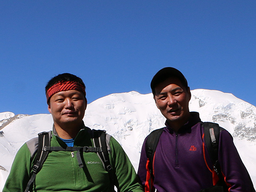 Mongolia Trekking guides with Mt.Khuiten in the background.